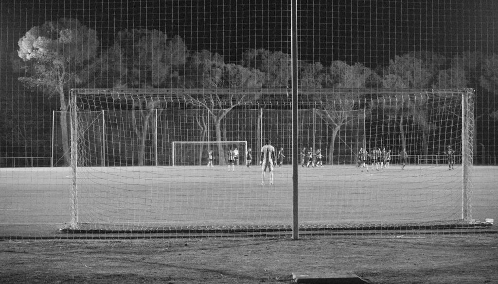 a black and white photo of a soccer field