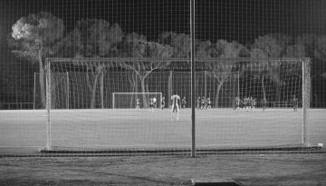 a black and white photo of a soccer field